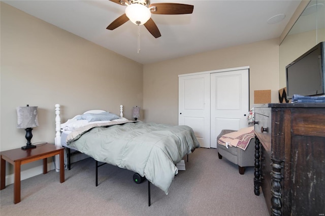 bedroom with a closet, carpet flooring, and ceiling fan