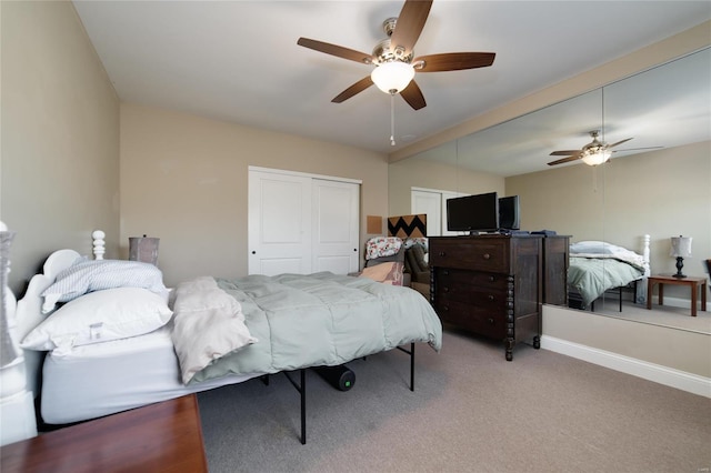 carpeted bedroom featuring a closet, ceiling fan, and baseboards