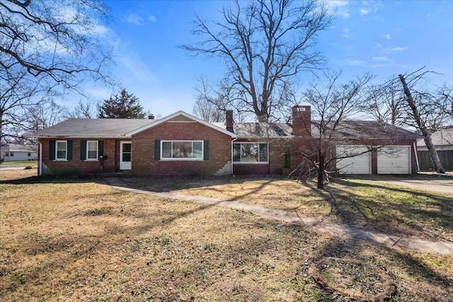 single story home with driveway, a chimney, a front lawn, a garage, and brick siding