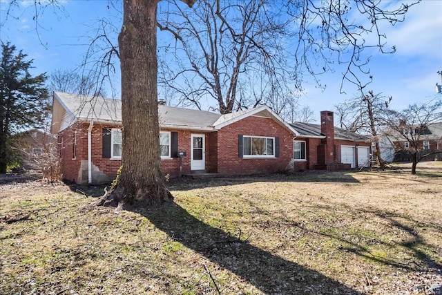 ranch-style house with a front lawn, an attached garage, brick siding, and a chimney