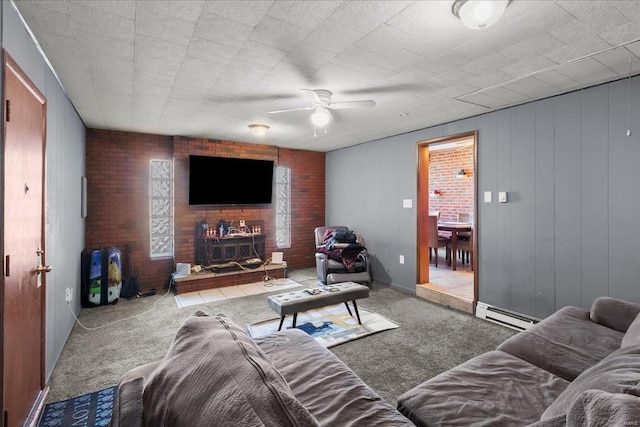 living room featuring brick wall, a ceiling fan, a baseboard heating unit, and carpet