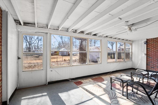 sunroom / solarium featuring a healthy amount of sunlight and a ceiling fan