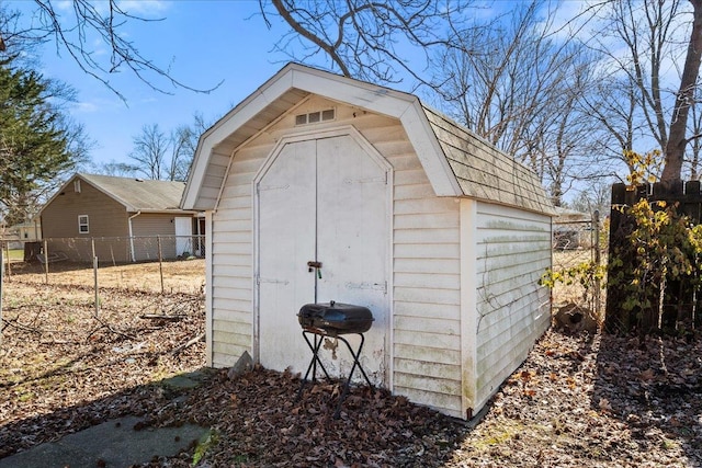 view of shed featuring fence