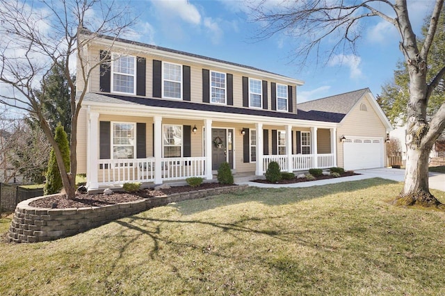 colonial-style house featuring covered porch, driveway, a front yard, and a garage