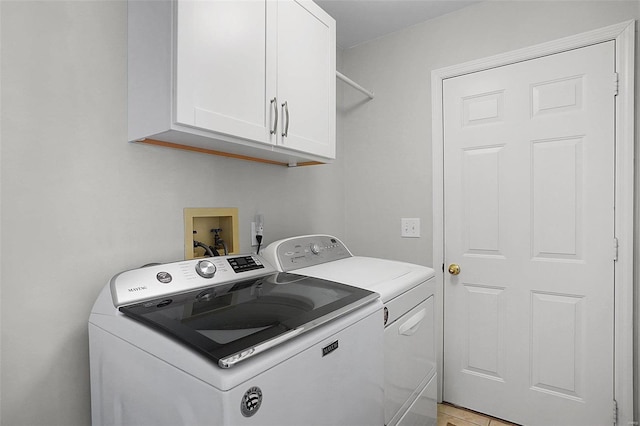 laundry room with cabinet space and independent washer and dryer