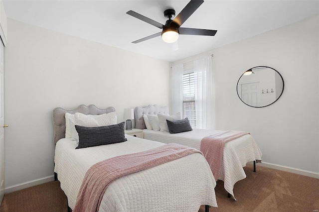 carpeted bedroom with a ceiling fan and baseboards