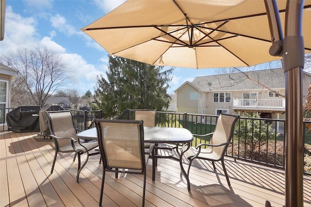 deck featuring a grill and outdoor dining area