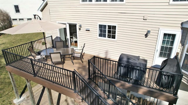 deck featuring outdoor dining space and area for grilling