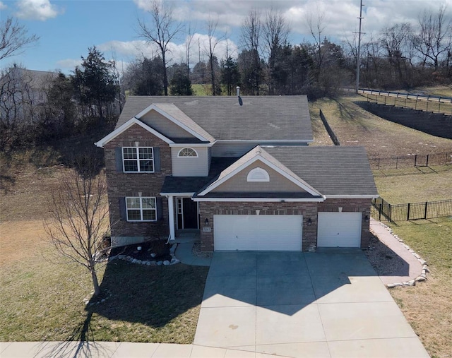 view of front of home with a front lawn, concrete driveway, fence, and an attached garage