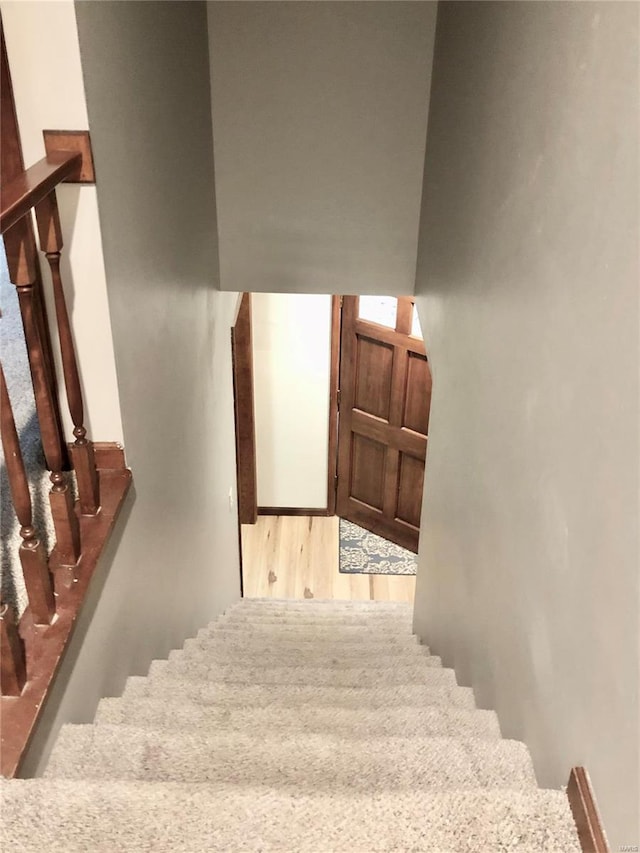 stairway featuring wood finished floors