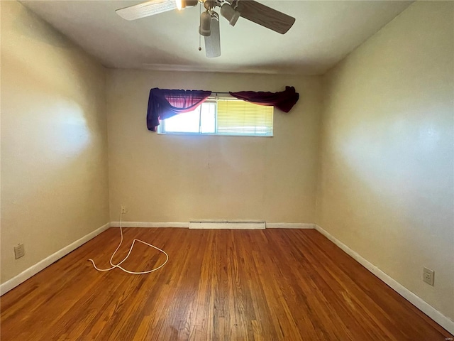 unfurnished room with a ceiling fan, wood finished floors, baseboards, and a baseboard radiator