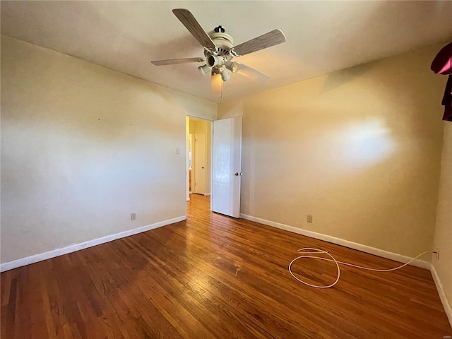 spare room with wood finished floors, baseboards, and ceiling fan