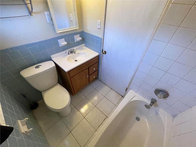 bathroom with tile patterned flooring, tile walls, a wainscoted wall, toilet, and vanity