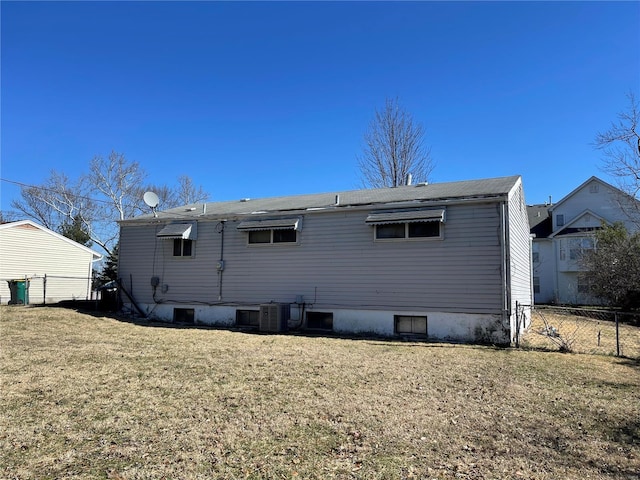 back of property featuring a yard and fence