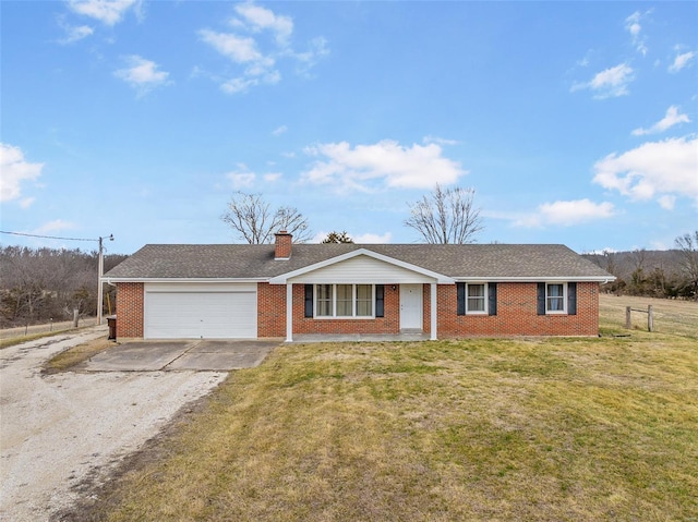 ranch-style house with a front lawn, fence, concrete driveway, an attached garage, and brick siding