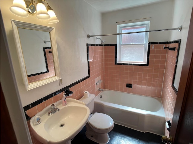 full bathroom featuring shower / bath combination, toilet, tile walls, and a sink