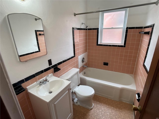 full bathroom featuring toilet, shower / tub combination, tile walls, tile patterned flooring, and vanity