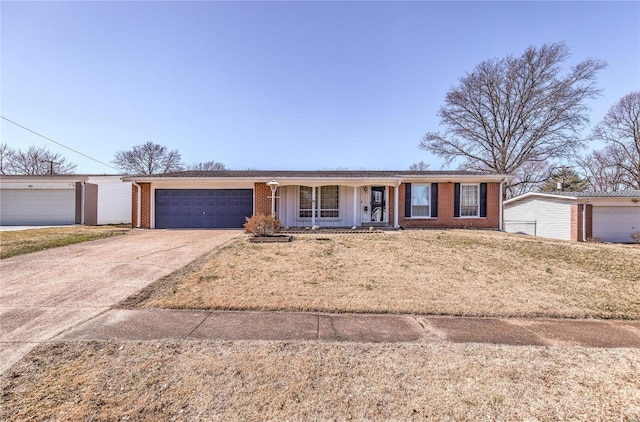 single story home with driveway, a porch, board and batten siding, a garage, and brick siding