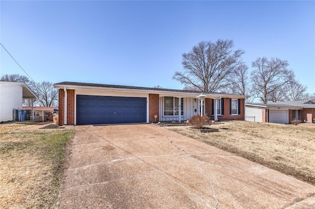 ranch-style home featuring a front yard, brick siding, concrete driveway, a garage, and board and batten siding