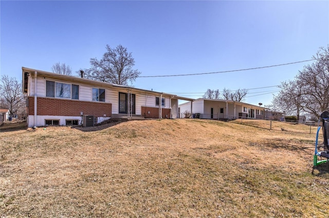 single story home with a front yard, fence, and brick siding