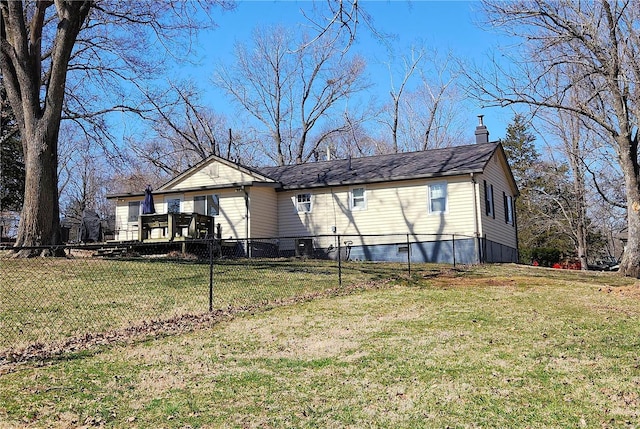 back of house with a lawn, fence, and a chimney