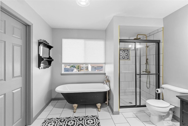 bathroom featuring a freestanding tub, toilet, a stall shower, tile patterned flooring, and baseboards