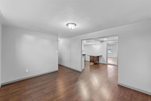 empty room with baseboards and wood finished floors