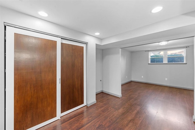 unfurnished bedroom featuring multiple closets, recessed lighting, baseboards, and wood finished floors