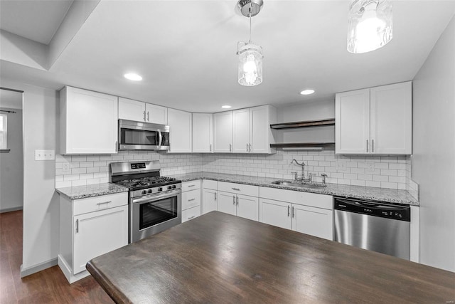 kitchen featuring a sink, appliances with stainless steel finishes, dark wood-style floors, and white cabinets