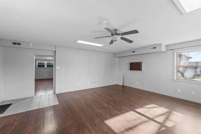 empty room featuring visible vents, wood finished floors, and a ceiling fan