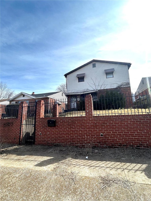 view of front of property featuring a fenced front yard and a gate