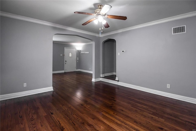 unfurnished room featuring visible vents, arched walkways, wood finished floors, and crown molding