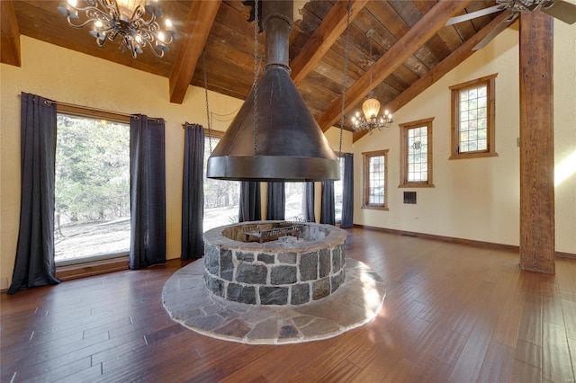 interior space featuring beamed ceiling, wood finished floors, a notable chandelier, and wooden ceiling