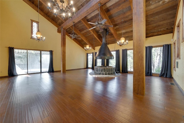 unfurnished living room with wooden ceiling, wood finished floors, visible vents, and beam ceiling