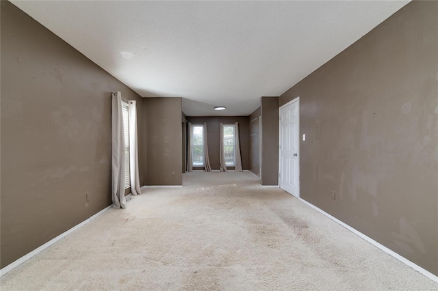 carpeted spare room with baseboards