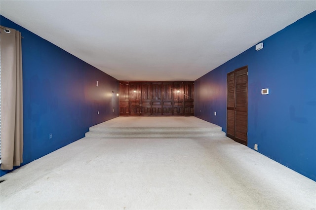 unfurnished room with carpet and an accent wall