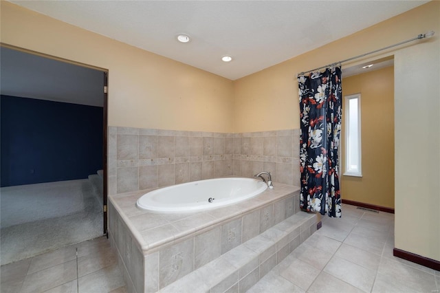 bathroom with tile patterned flooring, a garden tub, baseboards, and visible vents