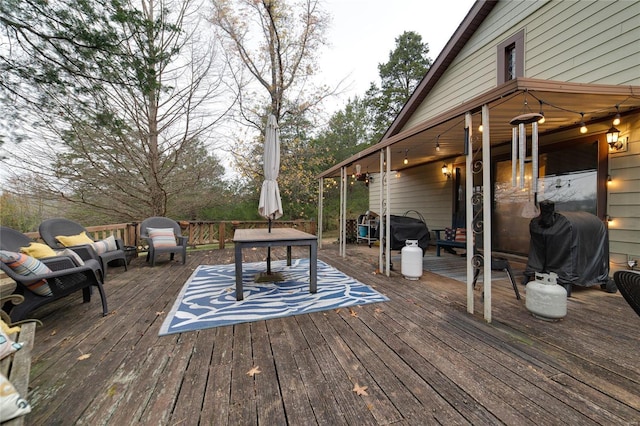 wooden terrace featuring a grill