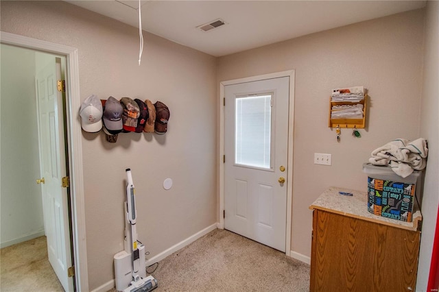 entryway featuring visible vents, baseboards, and light colored carpet