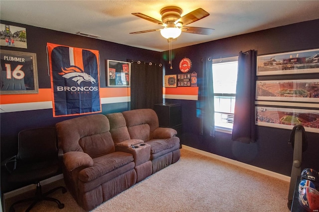 carpeted living area featuring visible vents, baseboards, and ceiling fan