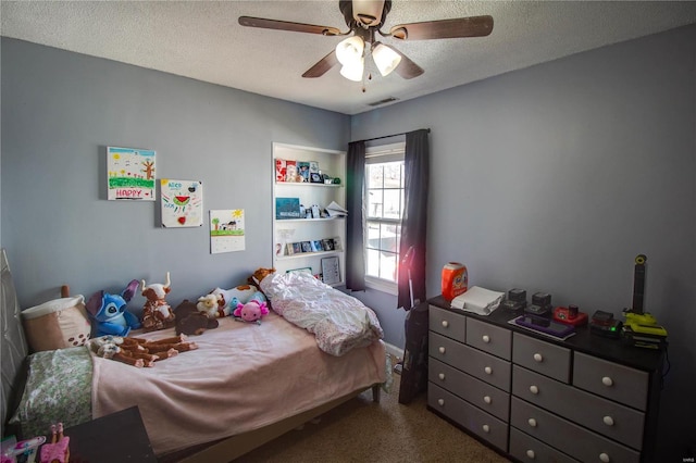 carpeted bedroom featuring visible vents, a textured ceiling, and ceiling fan