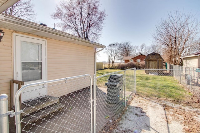 view of side of property featuring a yard, an outbuilding, fence private yard, and a gate