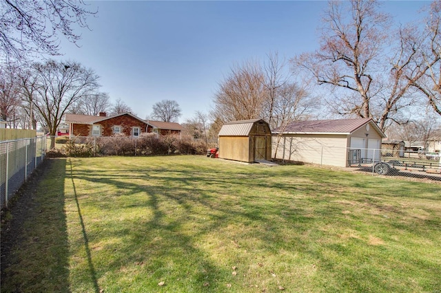 view of yard with an outdoor structure, a storage unit, and a fenced backyard