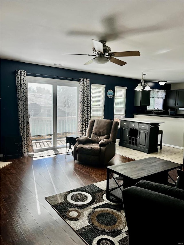 living area featuring light wood-style floors and ceiling fan