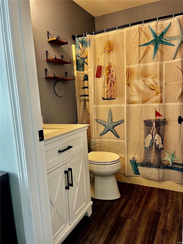 full bath featuring vanity, toilet, and wood finished floors