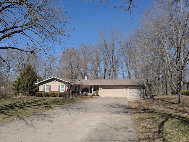 ranch-style home with a front lawn, a chimney, concrete driveway, and an attached garage