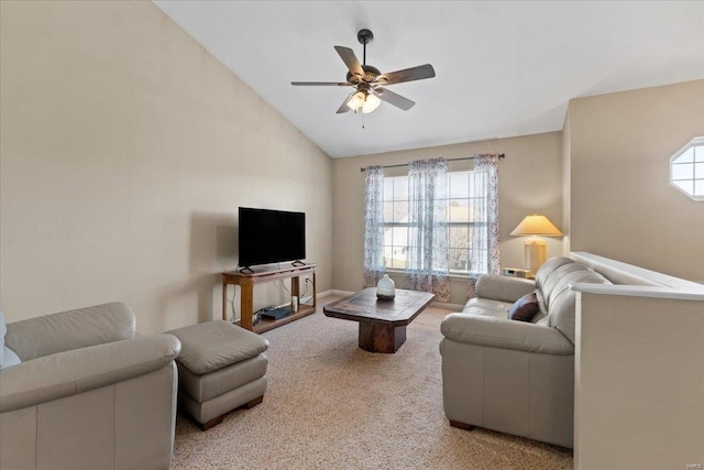 carpeted living area featuring lofted ceiling, a ceiling fan, and baseboards