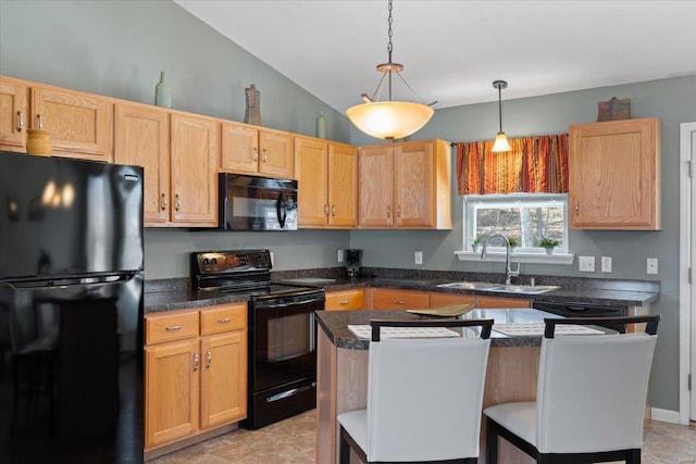 kitchen featuring dark countertops, vaulted ceiling, hanging light fixtures, black appliances, and a sink