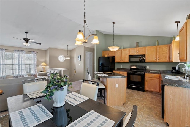 kitchen with black appliances, a sink, dark countertops, a kitchen island, and open floor plan