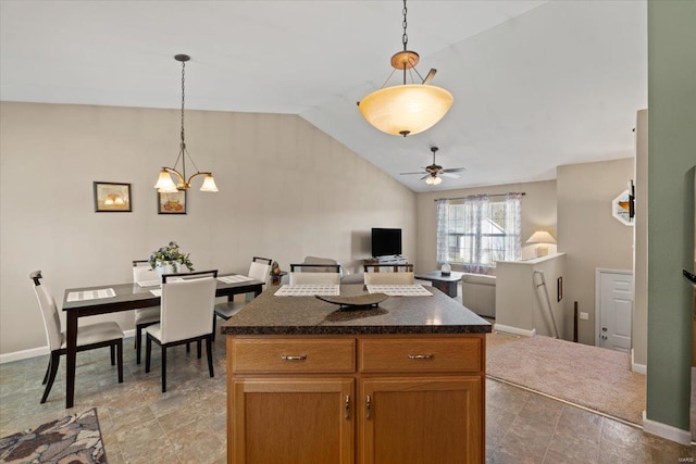 kitchen featuring a center island, open floor plan, pendant lighting, vaulted ceiling, and a ceiling fan